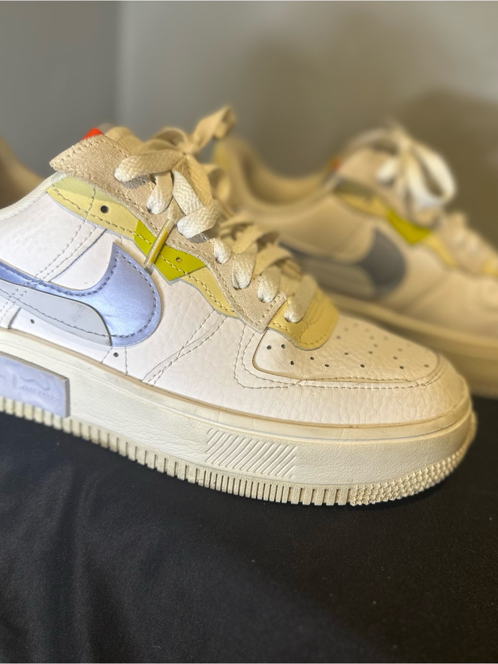 Nike Kids White Sneakers with Iridescent Blue Swoosh and Lemon Yellow Accents